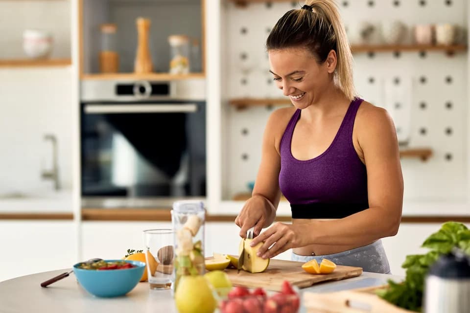woman in kitchen cooking a healthy meal